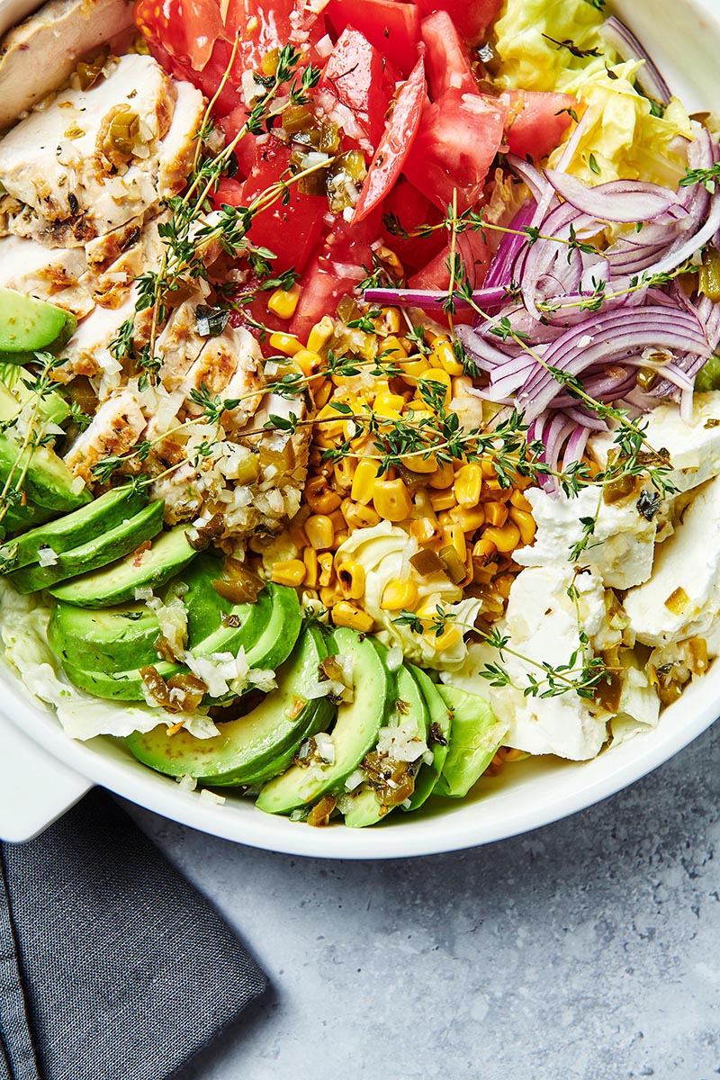 Colorful Grilled Chicken Salad in a white bowl.