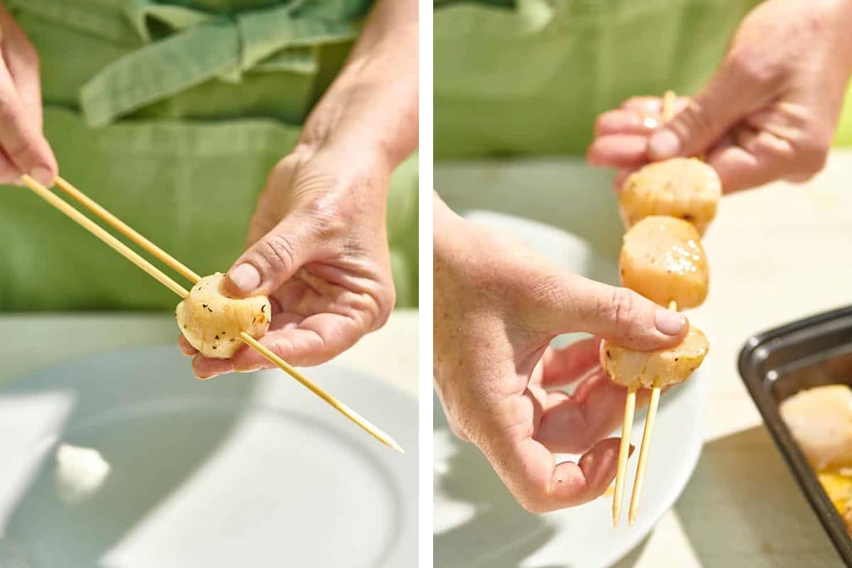 Woman sliding a scallop onto wooden skewers.