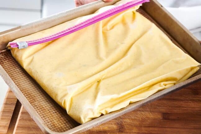 Zip top bag of ice cream on a baking sheet.