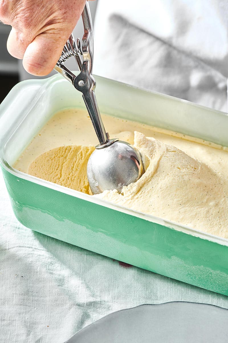 Ice cream scoop in a container of No Churn Ice Cream.