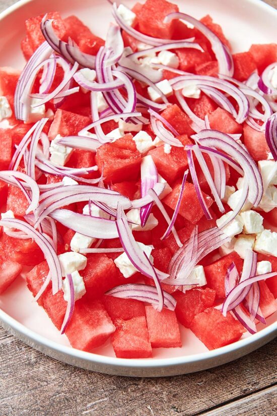 Watermelon topped with feta and red onion.