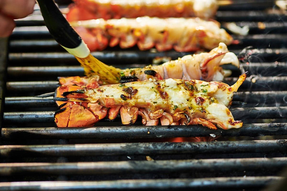 Brushing butter onto a lobster tail.