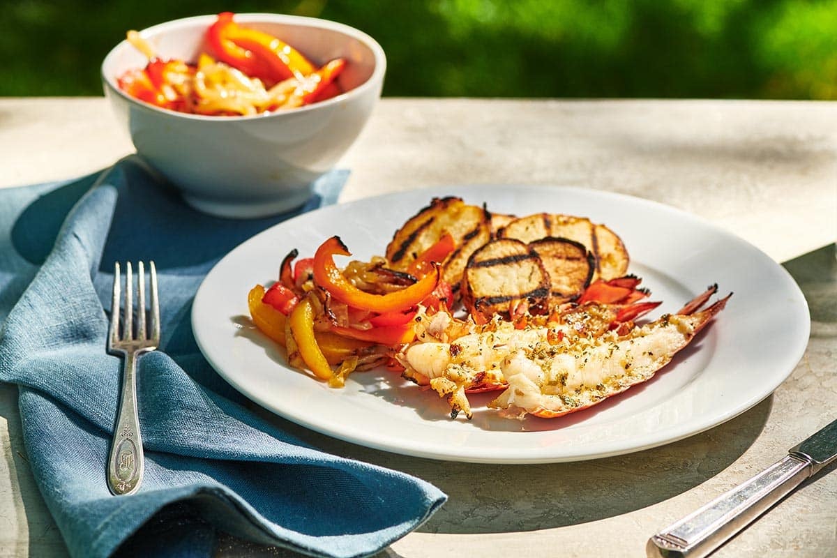 Grilled split lobster tail on plate with sides at BBW.