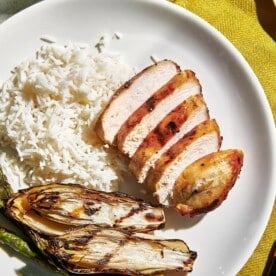 Grilled Soy Ginger Chicken Breasts on plate with grilled endive and rice.