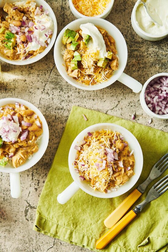 Four bowls of White Chicken Chili on a table.