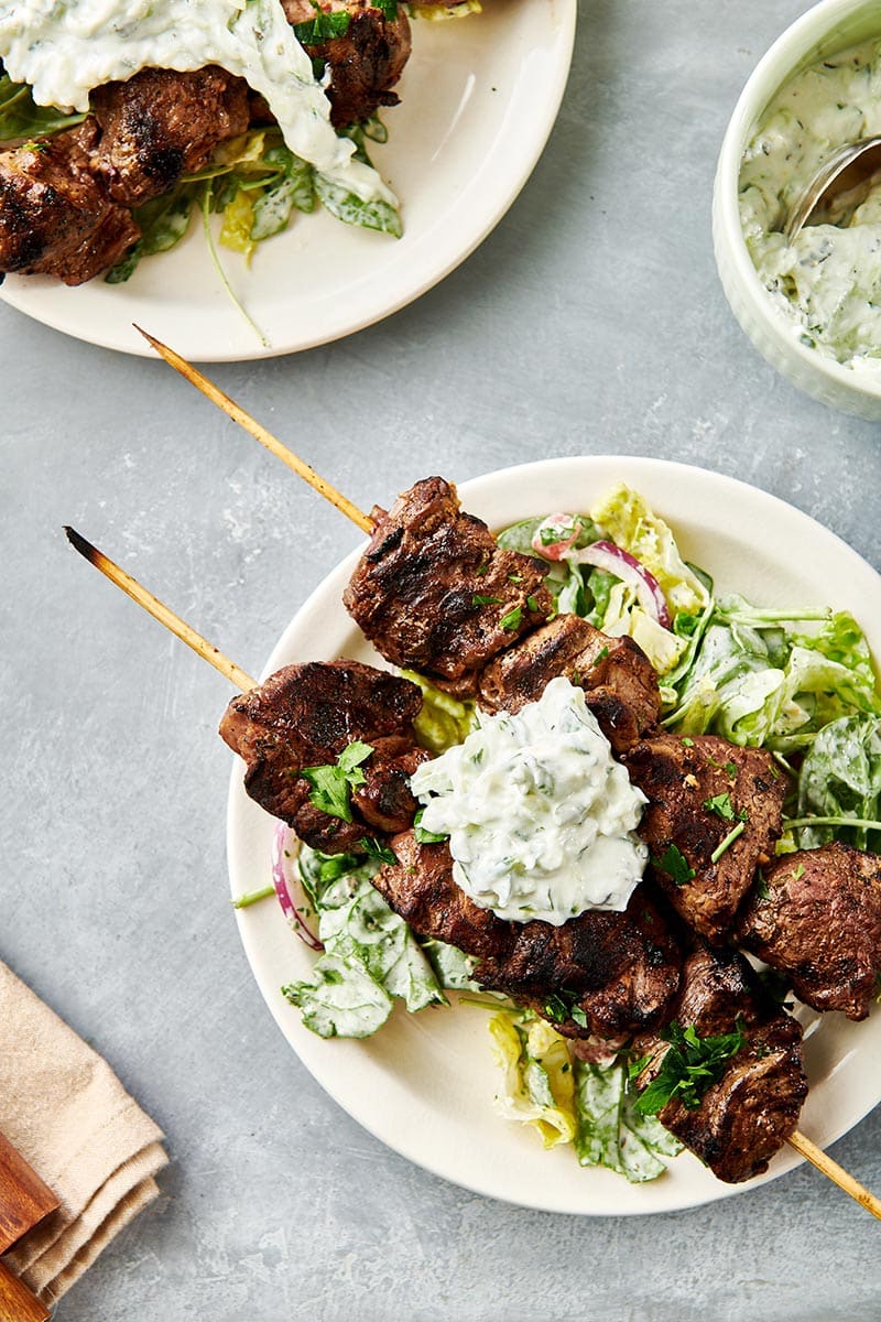 Greek Lamb Kabobs on a bed of greens.