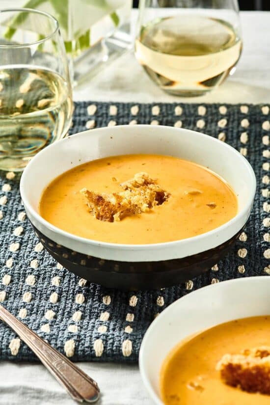 Bowl of Pumpkin Curry Soup topped with croutons.
