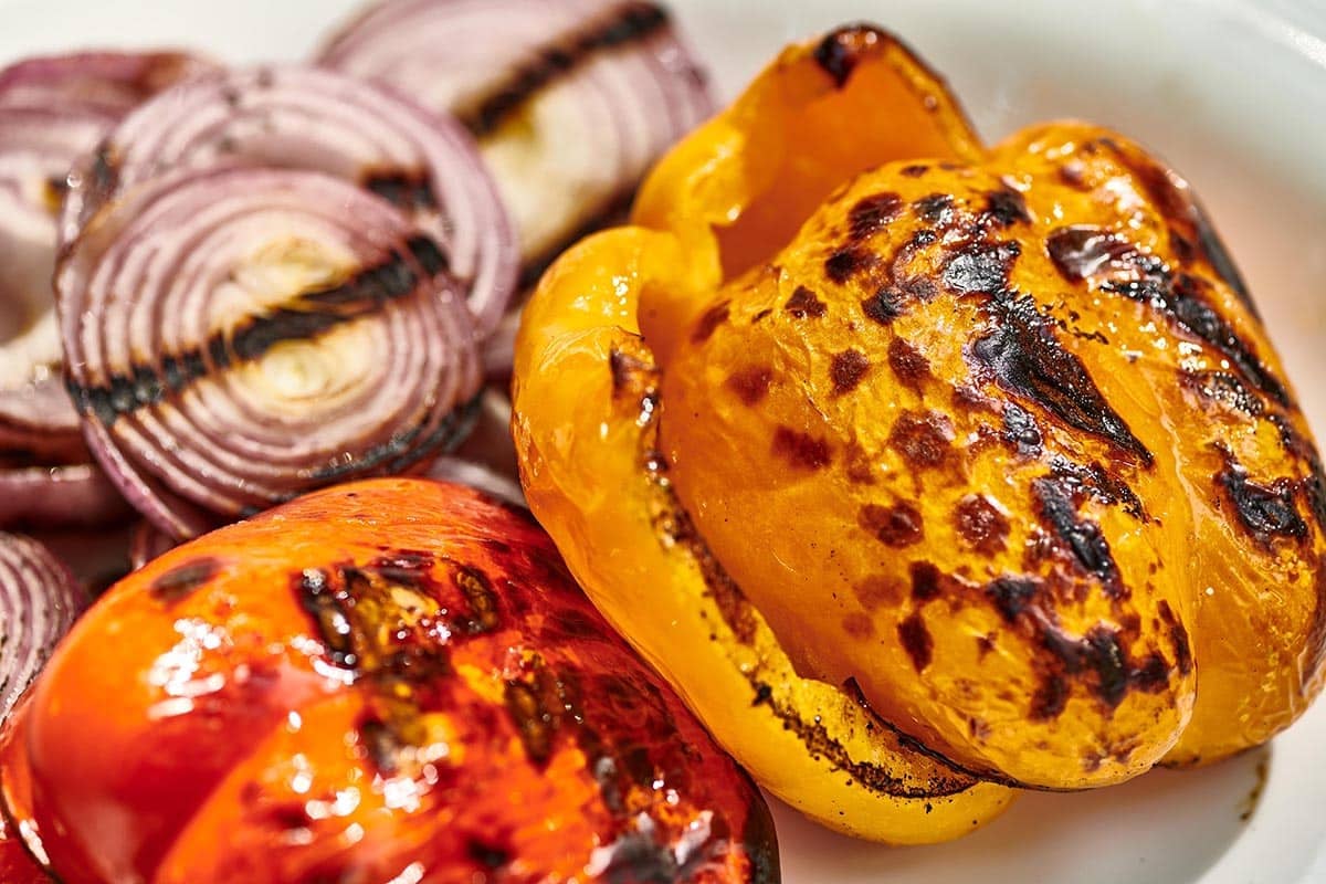 Grilled peppers and onions on plate.