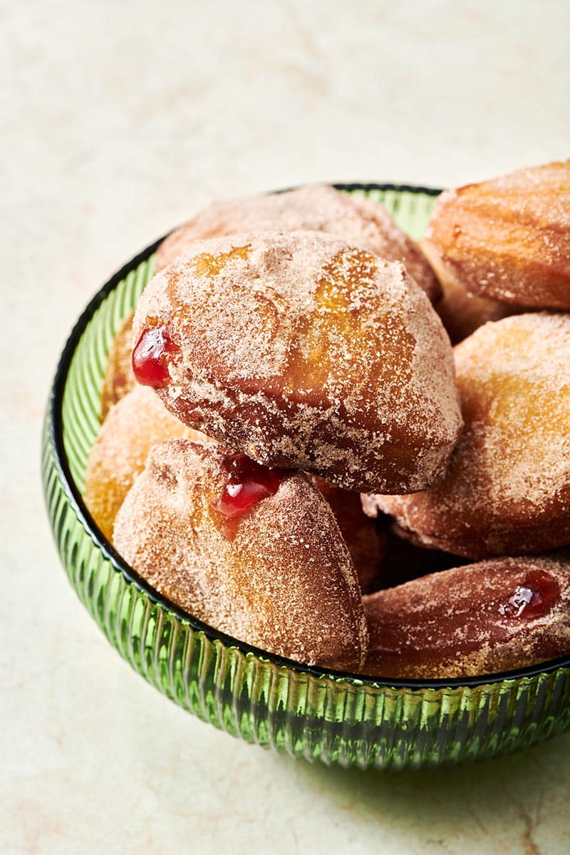 Jelly Doughnuts piled high in a bowl.