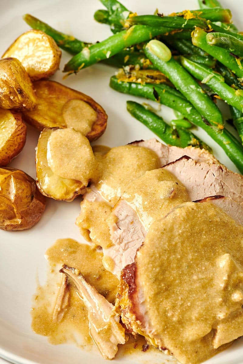 Milk Braised Pork on a plate with green beans and potatoes.