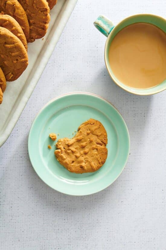Partially-eaten Peanut Butter Cookie on a small plate.
