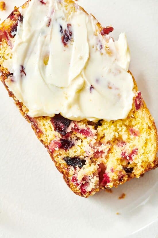 Generous serving of butter on a slice of Orange Cranberry Bread.
