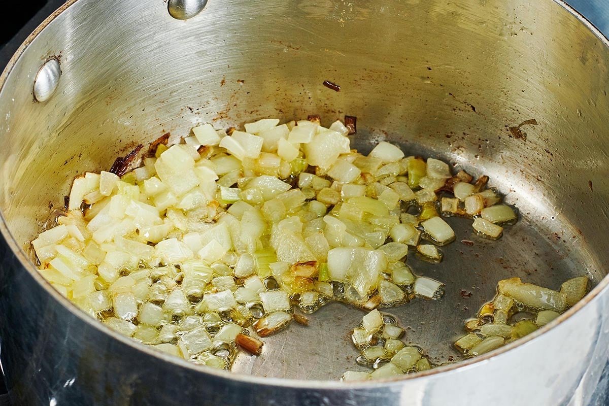 Diced onions and garlic in a pot.