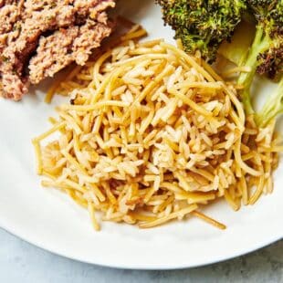 Rice Pilaf served on a plate with meatloaf and broccoli.
