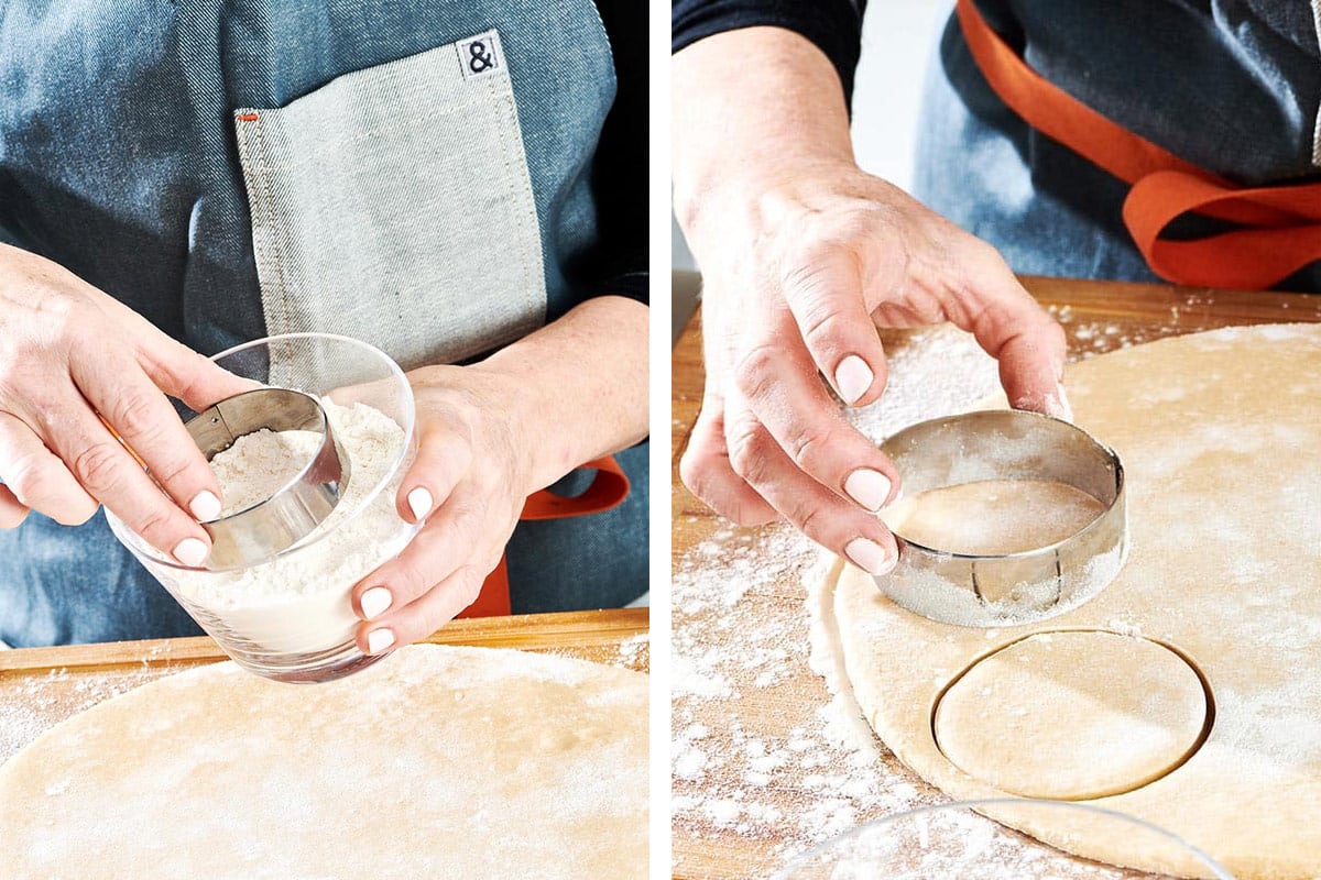Woman using round cookie cutter with doughnut dough.