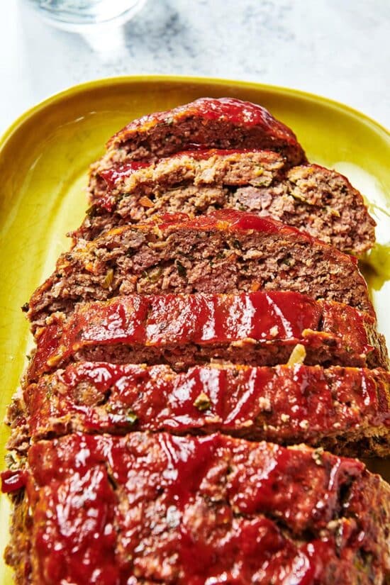 Slices of Meatloaf lined up on a dish.