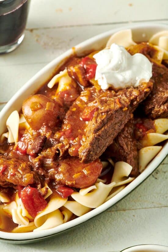Hungarian Goulash on a bed of egg noodles and topped with sour cream.
