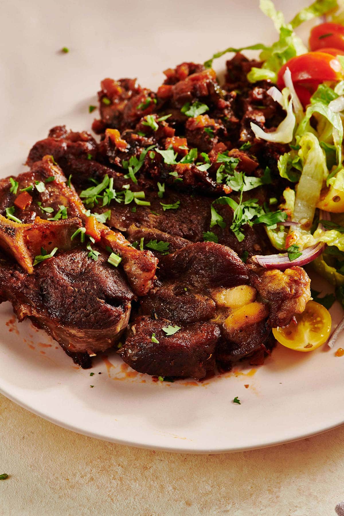 Braised Lamb Shoulder Chops on a white plate.