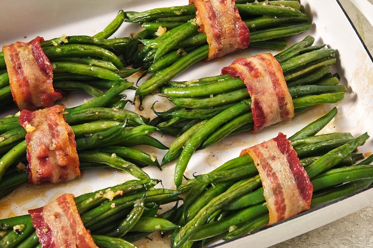 Bacon wrapped around groups of green beans.