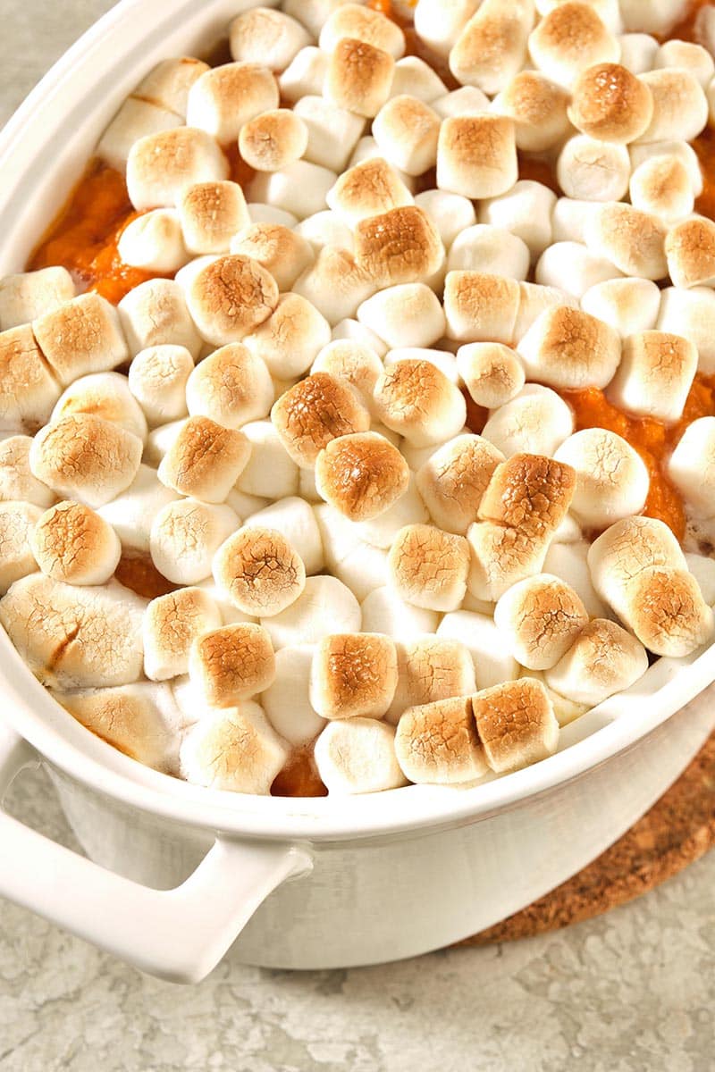 Sweet Potato Casserole with Marshmallows in a white baking dish.