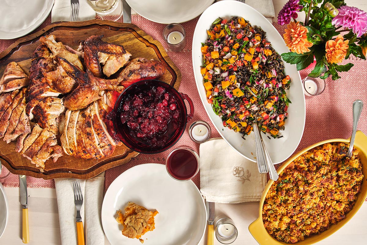 Wild Rice and Sweet Potato Salad on a table with stuffing, turkey, and other dishes.