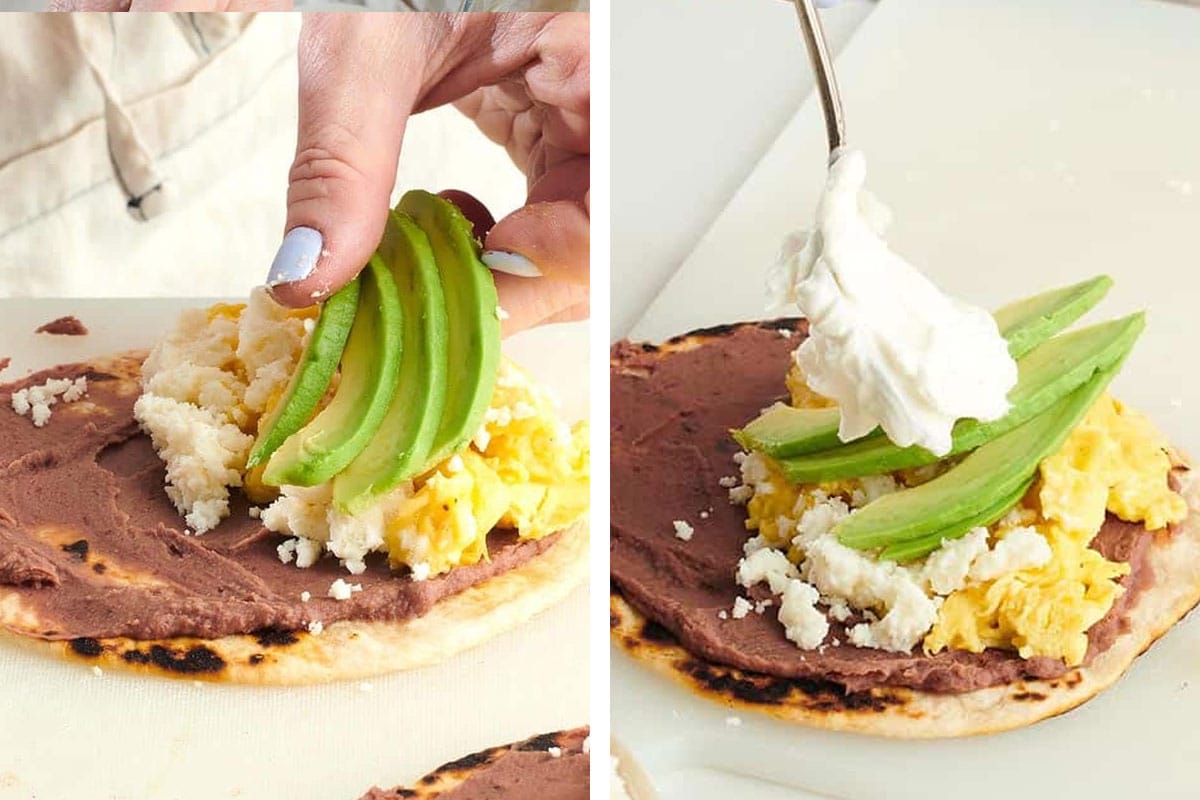 Woman placing avocado slices and sour cream onto a Baleada.