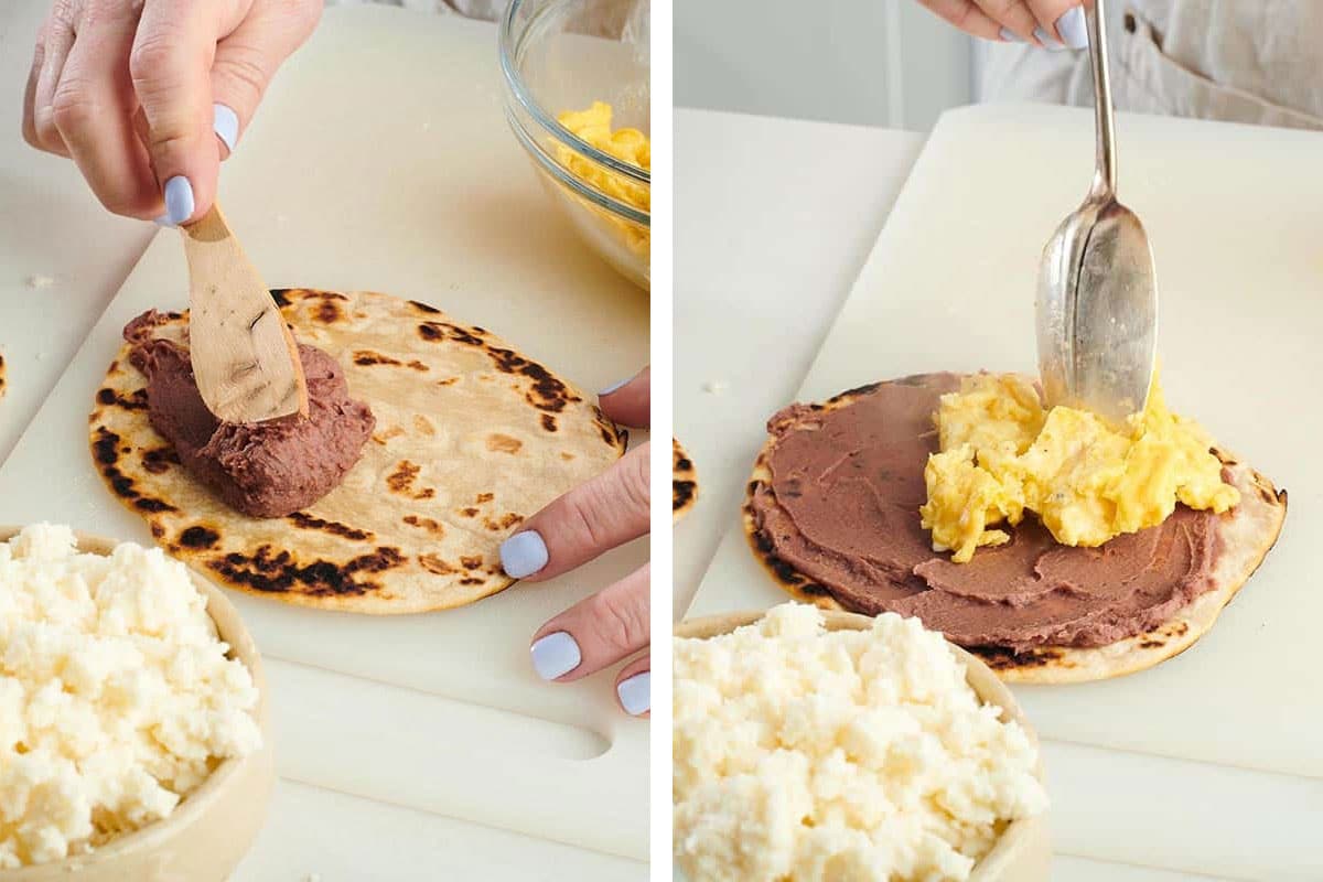 Woman spreading refried beans and scrambled eggs on tortilla.