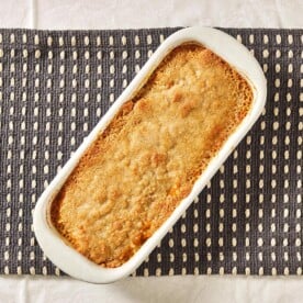 Butternut Squash Casserole in white dish on table.