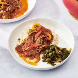 Ropa Vieja in plate with cooked greens.