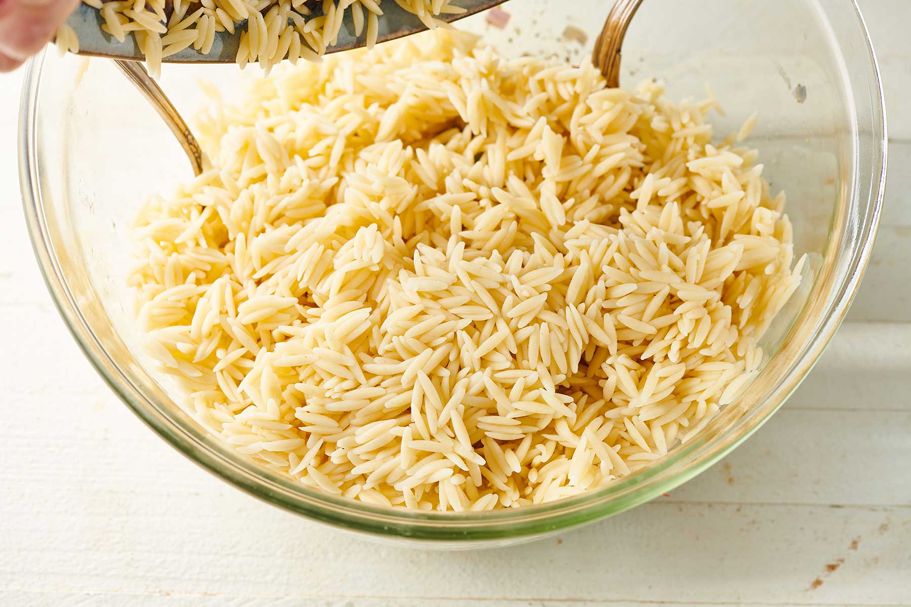 Cooked orzo pasta in bowl.