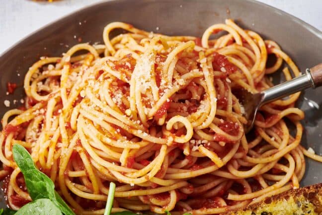 Fork in bowl of spaghetti with fresh marinara sauce