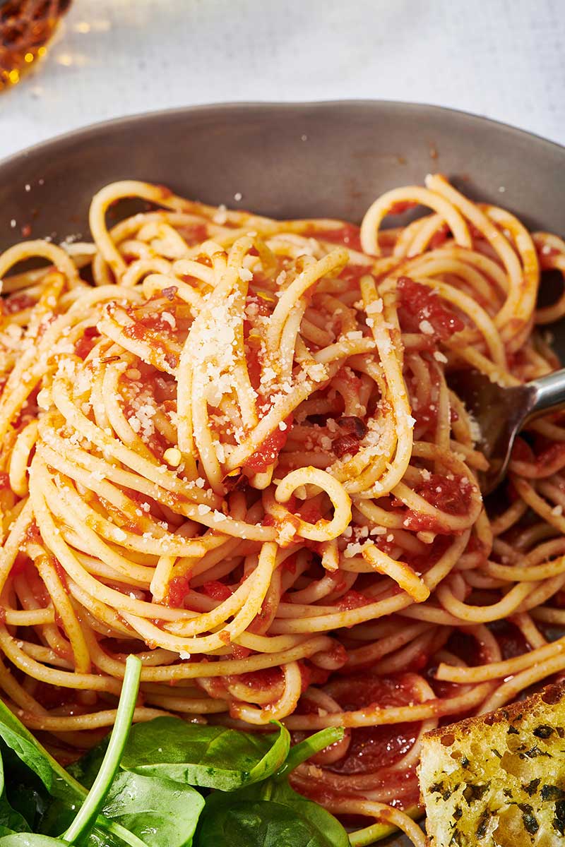 Homemade Marinara Sauce with spaghetti on brown plate.