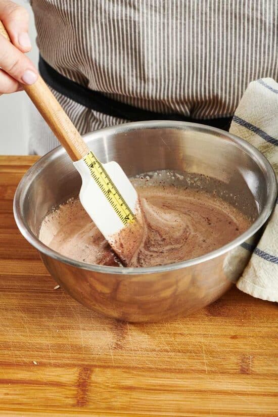 Stirring cream and chocolate to make ganache