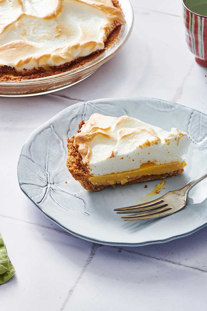 Slice of Key Lime Pie on a plate with a fork.