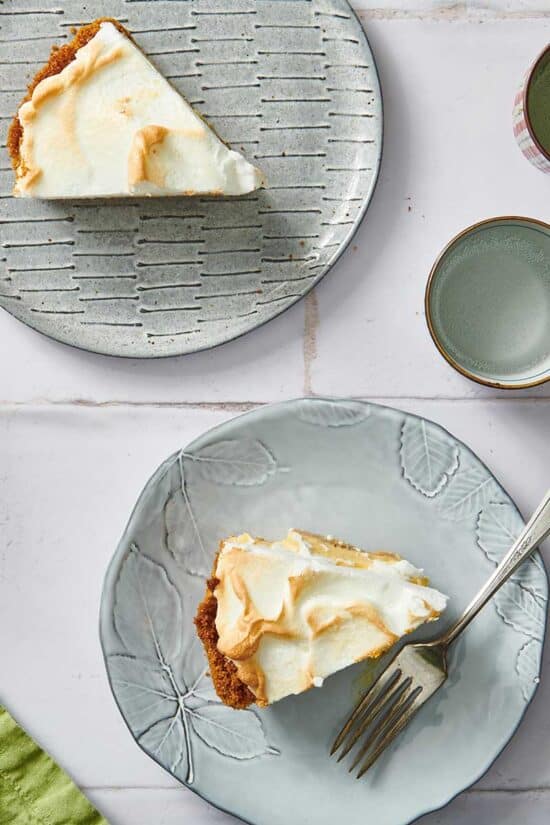 Two slices of Key Lime Pie on two decorated plates.