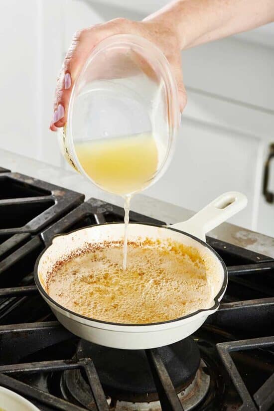 Adding lemon juice to pan of butter sauce