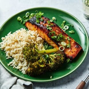 Miso Salmon on a plate with broccoli and rice.