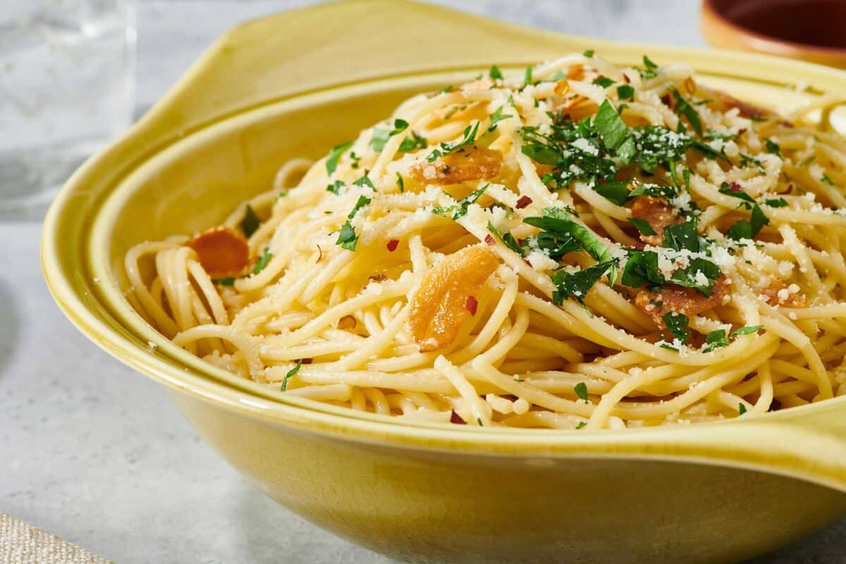Pasta Aglio e Olio in yellow dish.