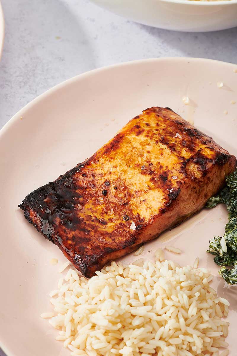 Air-Fried Salmon on pale plate with side of rice.
