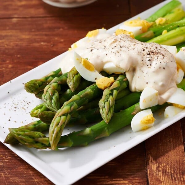 Asparagus with remoulade sauce and eggs on platter