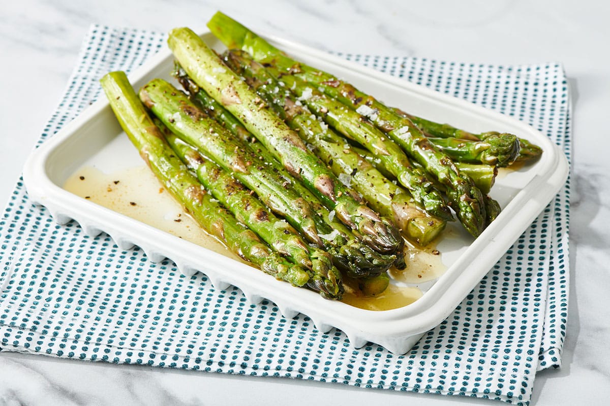 Asparagus with lemon butter sauce on platter