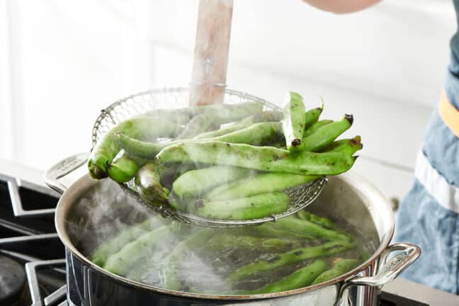 Straining blanched fava beans