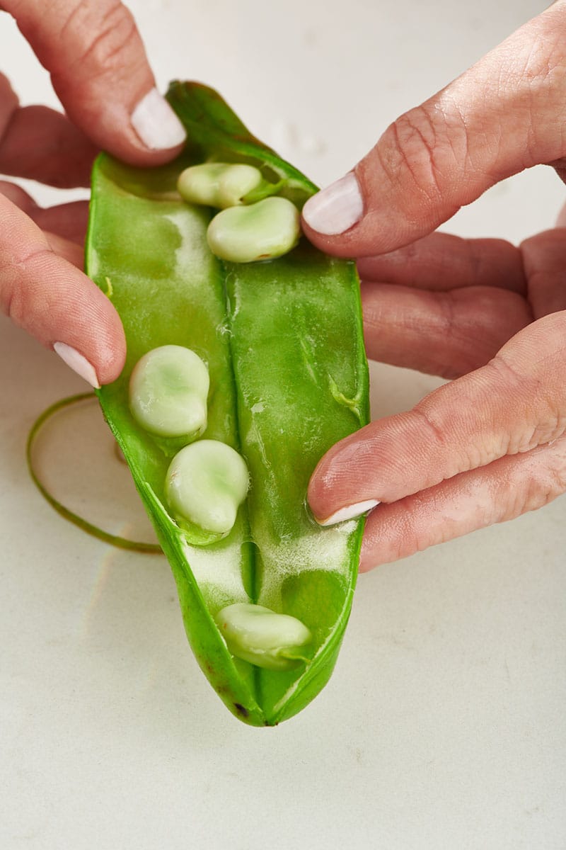 Removing fava beans from pod