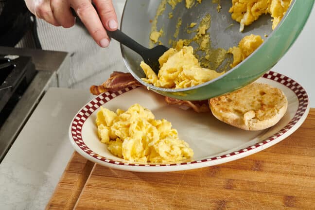 Adding scrambled eggs to plate