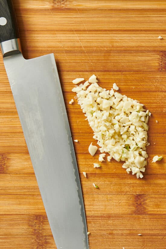 Finely minced garlic and knife