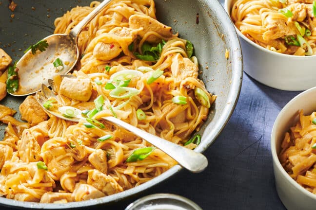 Chicken stir-fry with rice noodles in serving bowl