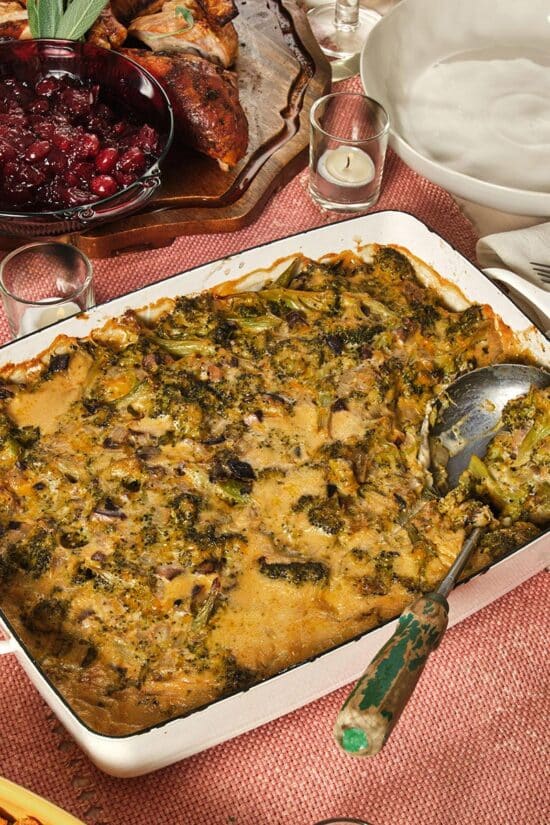 Broccoli casserole on table with cranberries