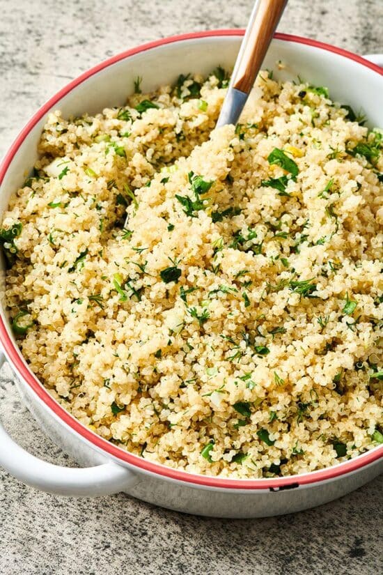 Quinoa salad with spoon in large pot
