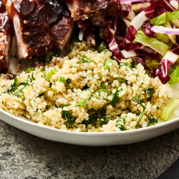 Quinoa salad with ribs and lettuce on plate.