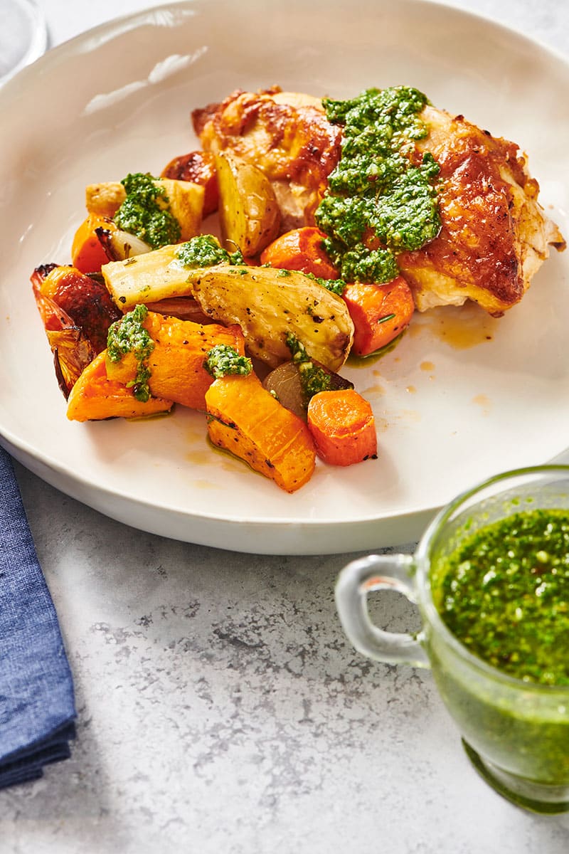 Chimichurri Sauce on top of chicken breast with roasted vegetables.